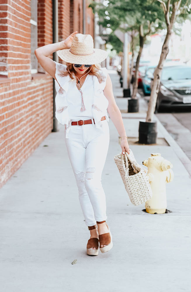 White jeans, white embroidered top featured by popular Los Angeles fashion blogger the hunter collector